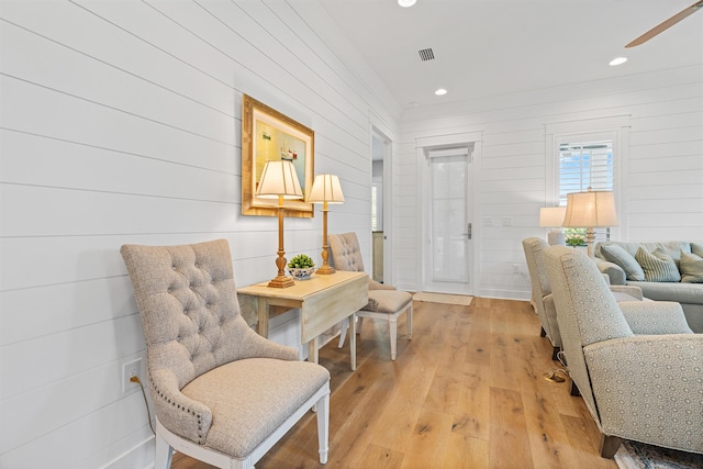 living area featuring ceiling fan and light wood-type flooring