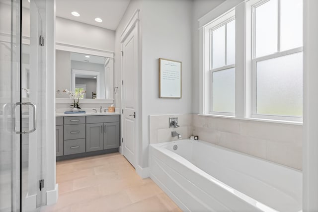 bathroom featuring tile patterned flooring, vanity, and separate shower and tub