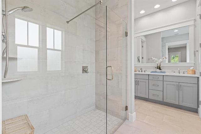 bathroom featuring vanity and a shower with shower door