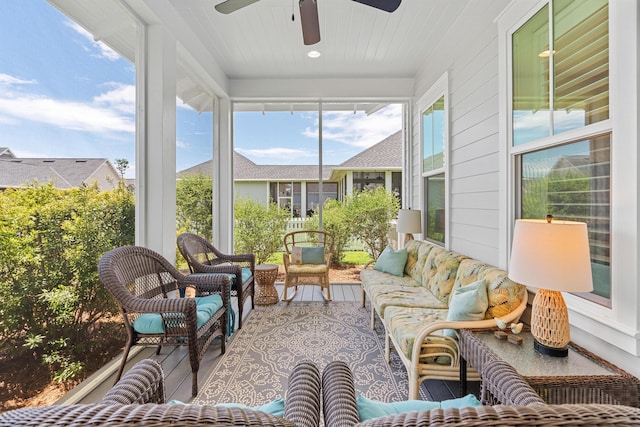 sunroom / solarium featuring ceiling fan