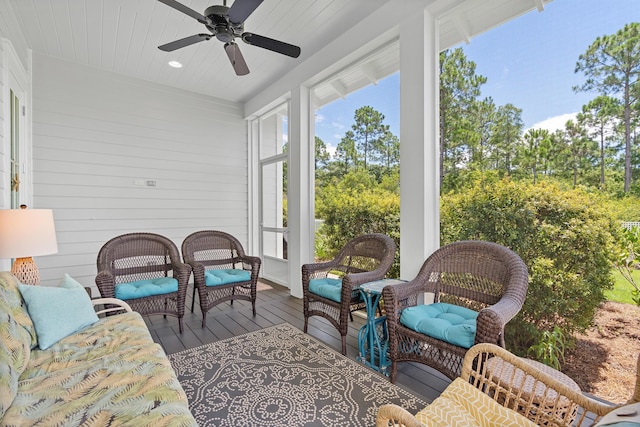 sunroom / solarium featuring ceiling fan