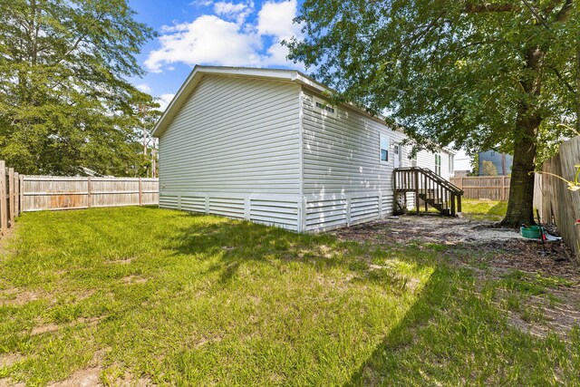 view of side of home featuring a lawn