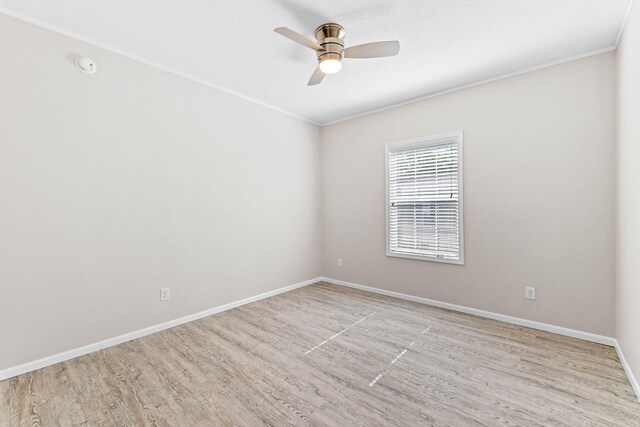 empty room with crown molding, light hardwood / wood-style floors, and ceiling fan