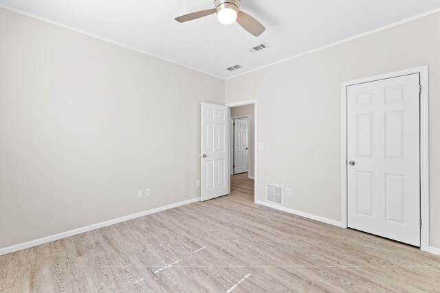 unfurnished bedroom featuring ornamental molding, light hardwood / wood-style floors, and ceiling fan