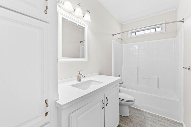 full bathroom featuring vanity, wood-type flooring, toilet, and washtub / shower combination