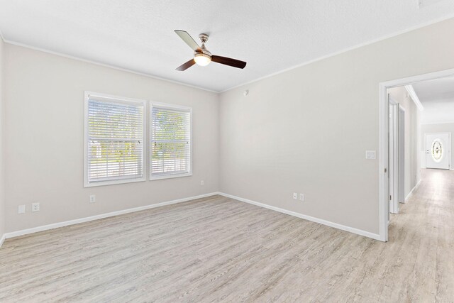 spare room featuring ornamental molding, ceiling fan, a textured ceiling, and light wood-type flooring