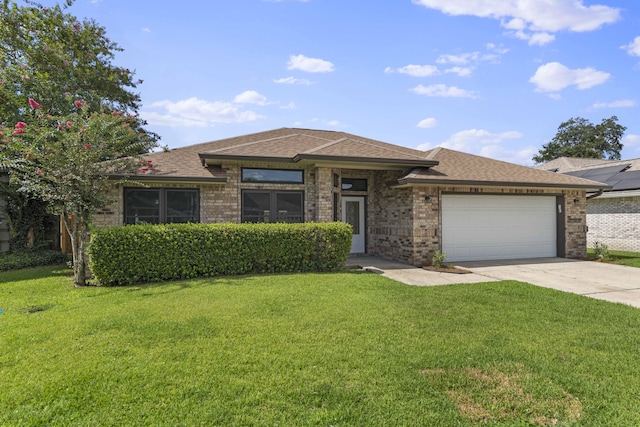 view of front of house featuring a garage and a front lawn