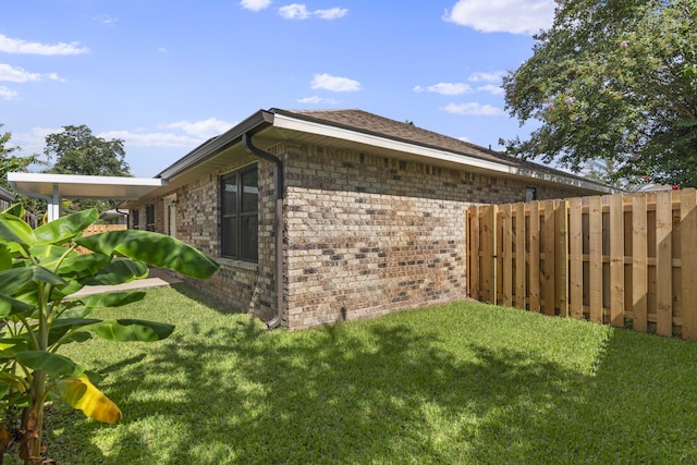 view of side of property with a lawn