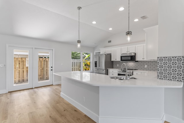 kitchen with pendant lighting, high end refrigerator, white cabinets, and kitchen peninsula