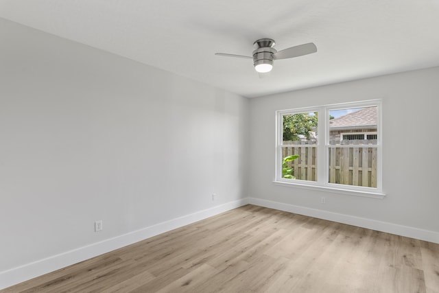 empty room with ceiling fan and light wood-type flooring