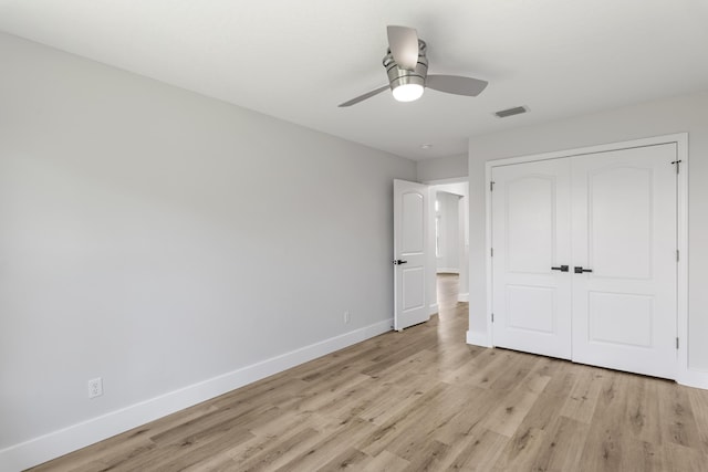 unfurnished bedroom with ceiling fan, a closet, and light hardwood / wood-style flooring