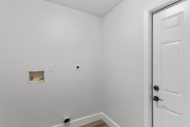 laundry area featuring hookup for a washing machine, electric dryer hookup, hardwood / wood-style flooring, and a textured ceiling