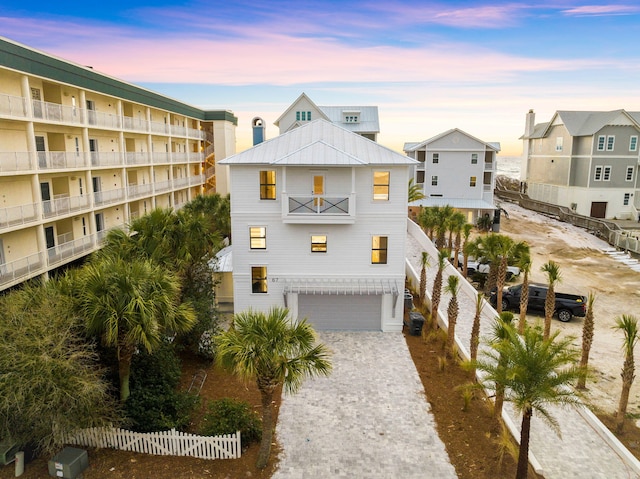 view of front of home with a garage and a balcony