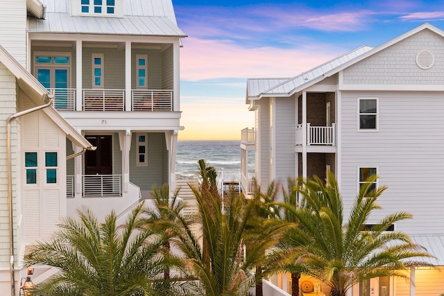 view of front of house featuring a balcony and a water view