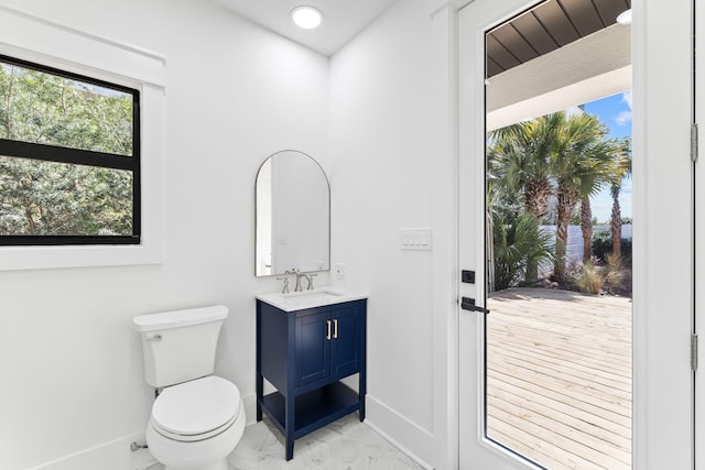 bathroom featuring tile patterned floors, toilet, and vanity