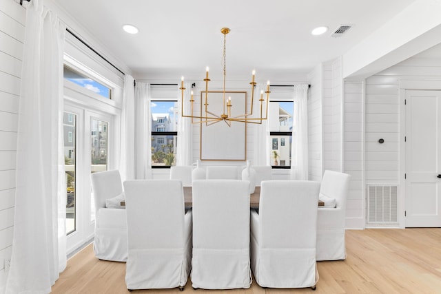 dining room featuring a notable chandelier and light hardwood / wood-style flooring