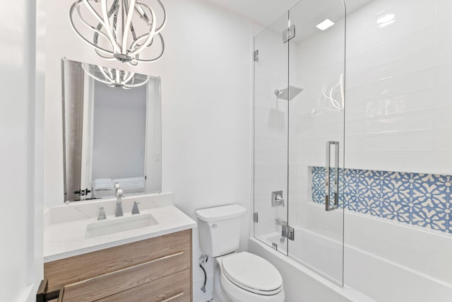 full bathroom with vanity, toilet, combined bath / shower with glass door, and a chandelier