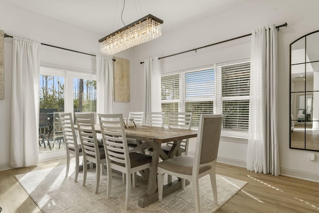 dining room featuring plenty of natural light, a chandelier, and light hardwood / wood-style floors