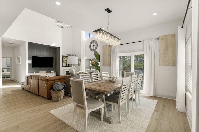 dining room featuring light hardwood / wood-style flooring and an inviting chandelier