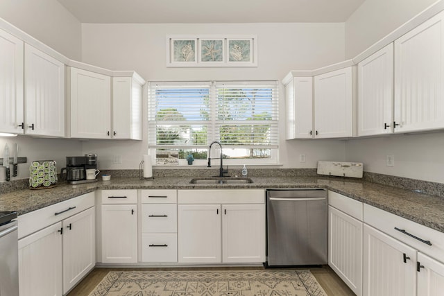 kitchen featuring white cabinets, stainless steel dishwasher, and sink