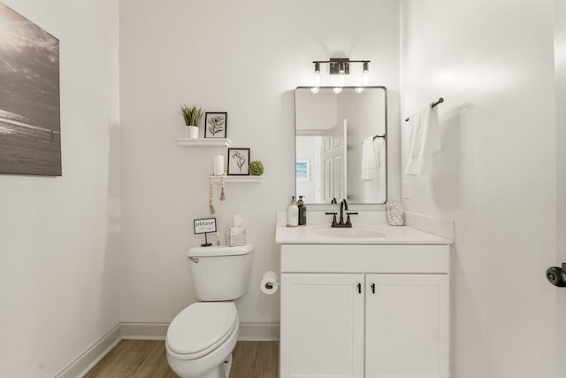 bathroom featuring hardwood / wood-style floors, vanity, and toilet