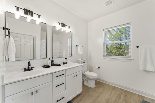 bathroom with hardwood / wood-style flooring, vanity, toilet, and a shower with shower curtain