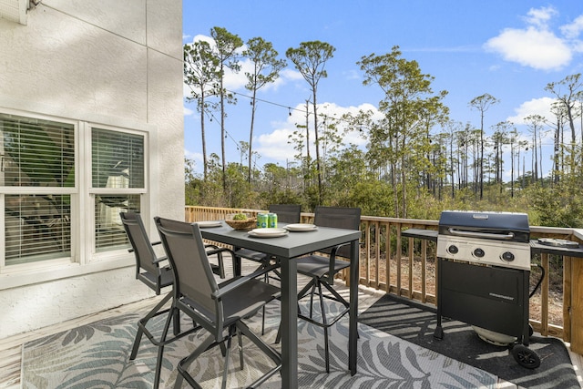 wooden deck featuring a grill