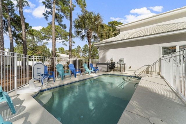 view of swimming pool featuring a patio and a hot tub