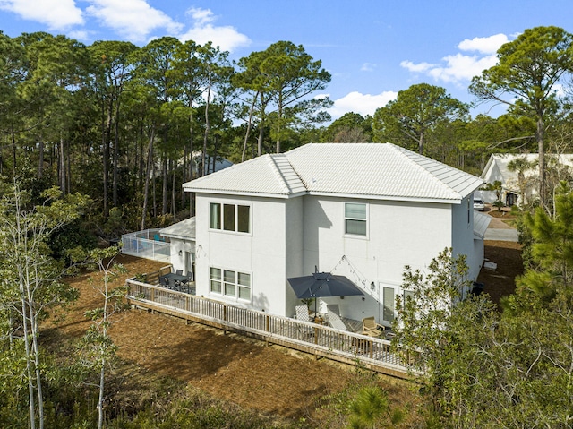 back of property featuring a swimming pool