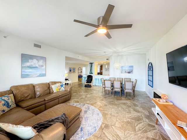 tiled living room with ceiling fan