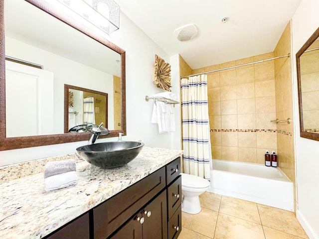 full bathroom with shower / tub combo, tile patterned floors, toilet, and vanity