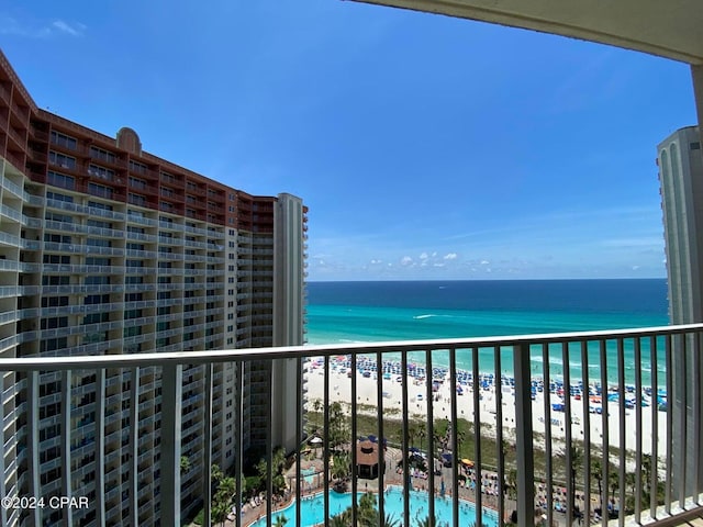 balcony featuring a beach view and a water view