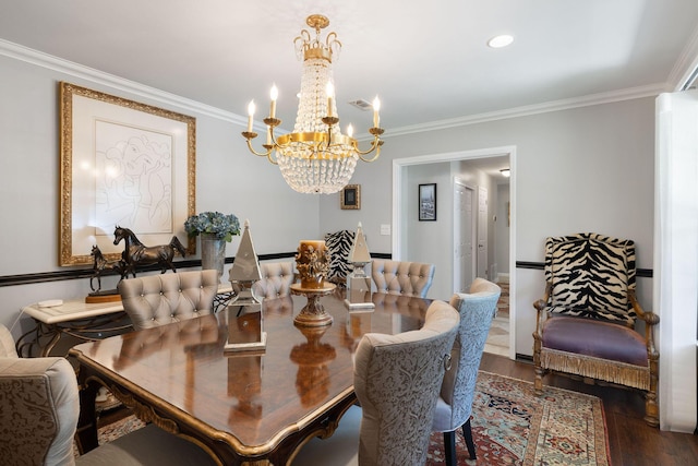 dining space featuring crown molding, dark wood-type flooring, and an inviting chandelier