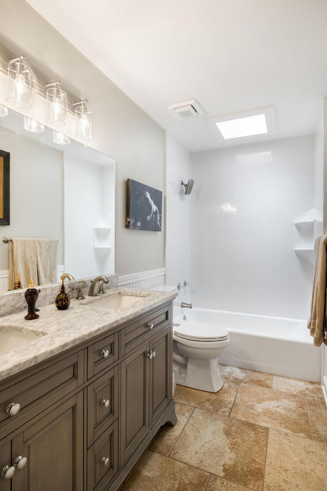 full bathroom featuring vanity, tub / shower combination, and toilet