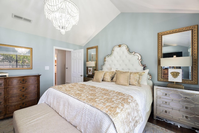 bedroom with hardwood / wood-style flooring, lofted ceiling, and a notable chandelier