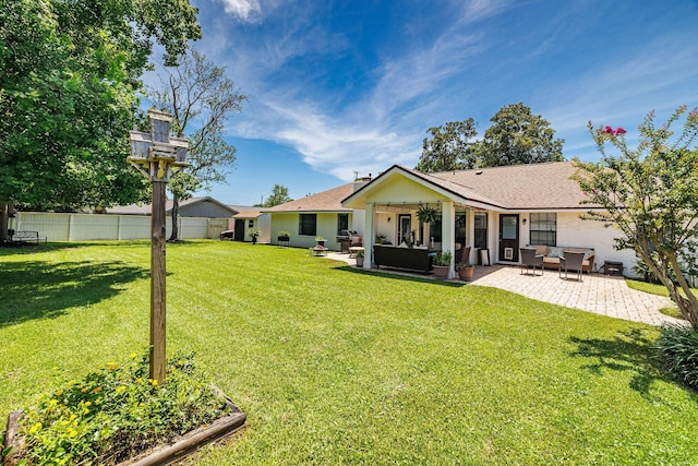 back of property with an outdoor living space, a yard, and a patio area