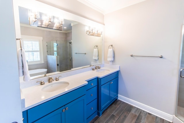 bathroom with a shower with shower door, crown molding, vanity, and wood-type flooring