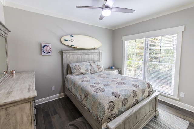 bedroom featuring dark wood-style floors, multiple windows, and ornamental molding