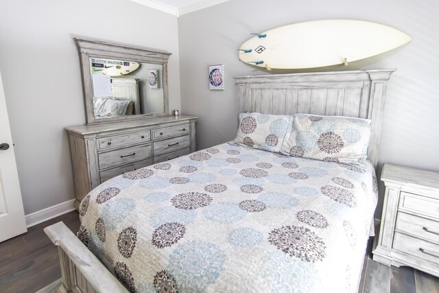 bedroom featuring dark wood-type flooring and ornamental molding