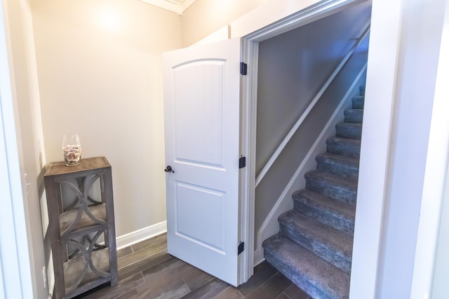 staircase with baseboards and wood finish floors