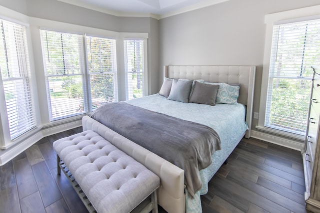 bedroom featuring ornamental molding, dark wood finished floors, and baseboards