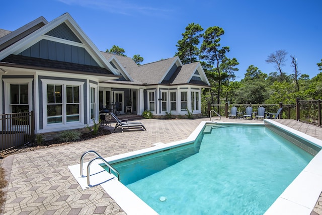 view of pool with a fenced in pool, a sunroom, a patio, and fence