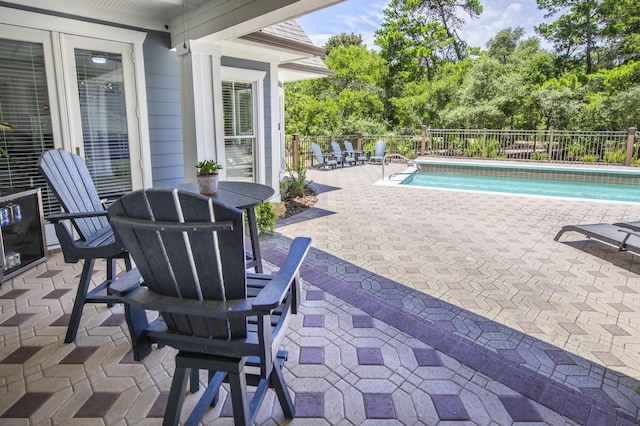 view of swimming pool featuring a patio area, a fenced backyard, and a fenced in pool