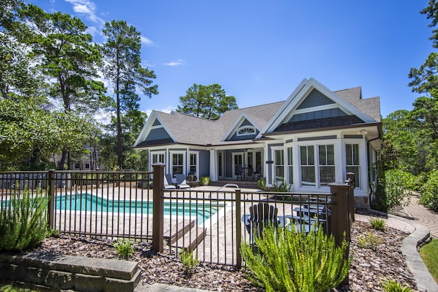 view of swimming pool featuring fence, french doors, a fenced in pool, and a patio