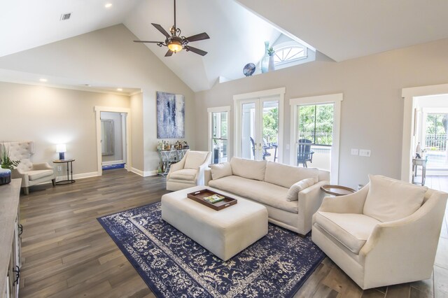 living room featuring ceiling fan, high vaulted ceiling, a healthy amount of sunlight, and dark hardwood / wood-style flooring