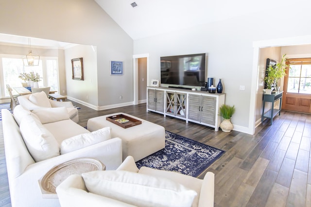 living area with baseboards, visible vents, high vaulted ceiling, and dark wood-type flooring