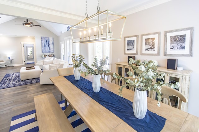 dining room with baseboards, a ceiling fan, lofted ceiling, dark wood-style floors, and crown molding