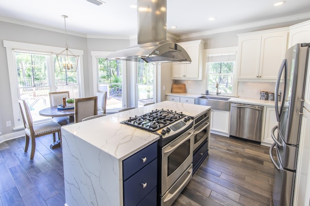 kitchen featuring island range hood, appliances with stainless steel finishes, white cabinets, and a sink