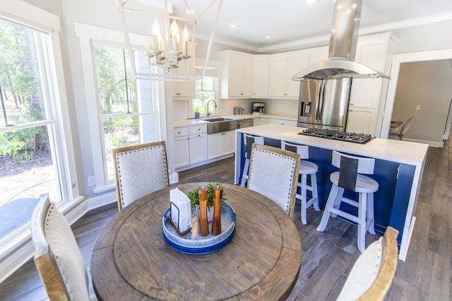 dining space featuring ornamental molding, dark wood-style flooring, and an inviting chandelier