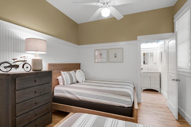 bedroom with ceiling fan, light hardwood / wood-style floors, and ensuite bathroom